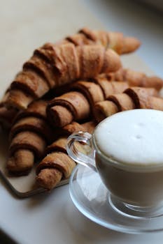 Enjoy a cozy breakfast with fresh croissants and a frothy cup of coffee.