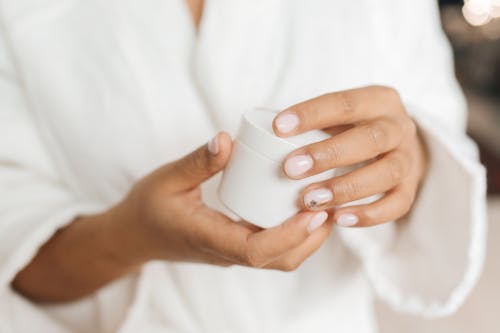 Person Holding White Plastic Container