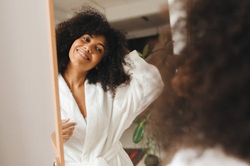 Free Woman Smiling in front of the Mirror Stock Photo