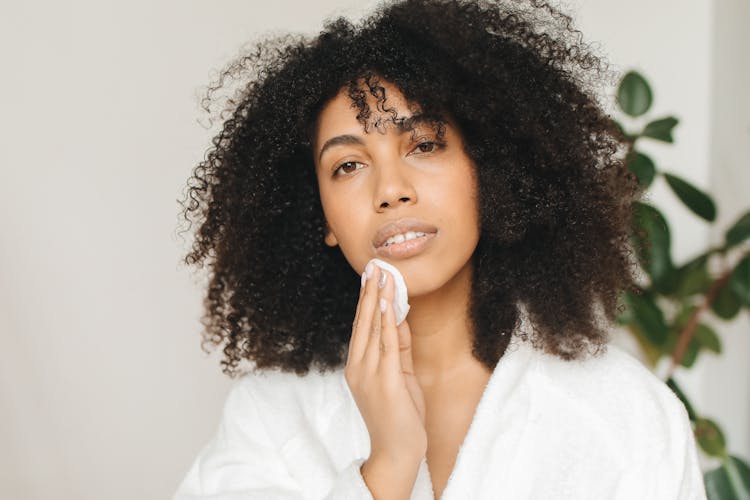 Woman Cleaning Her Face With Cotton Pad