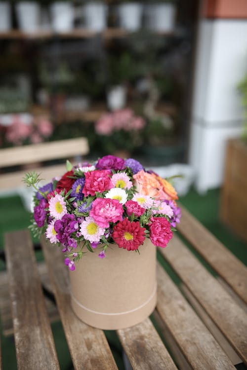 Pink and White Flower Bouquet on Brown Wooden Table