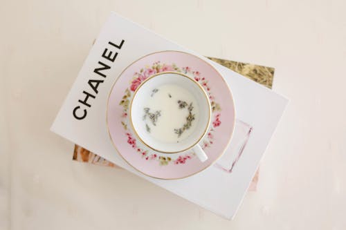 Free Pink Floral Saucer and White Teacup on White Book Stock Photo