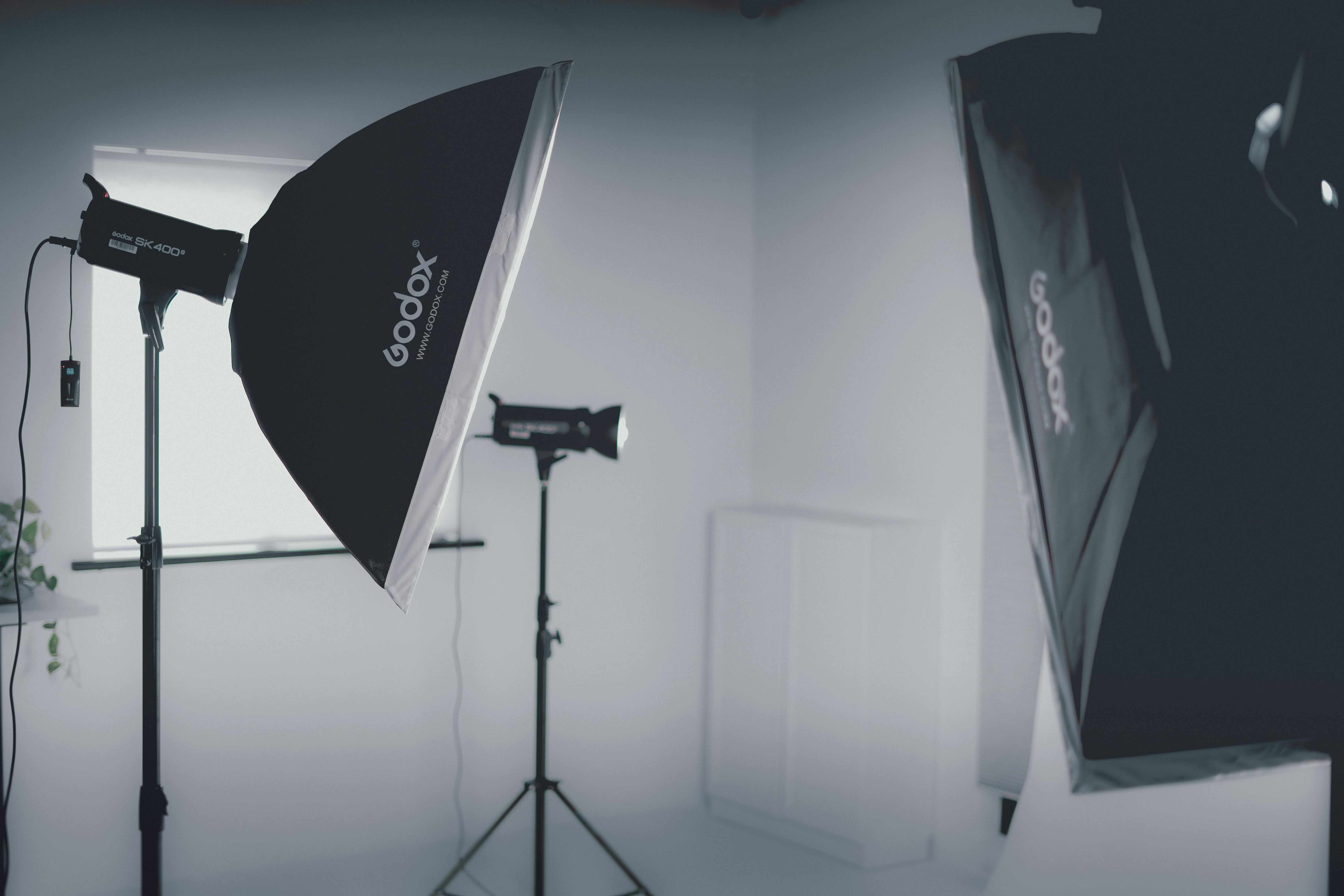 Modern photo studio with softbox lighting equipment in a minimalist setting.