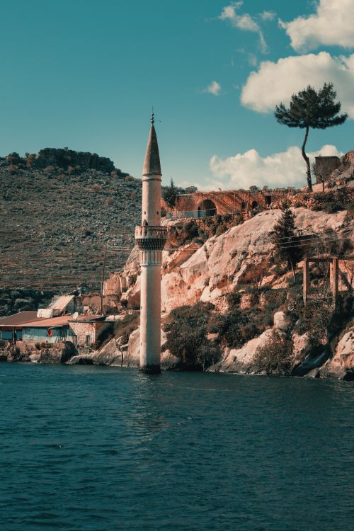 Free Scenic view of a sunken minaret at Halfeti with serene waters and rocky landscape. Stock Photo