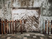 A Worn Out Metal Fence and Door