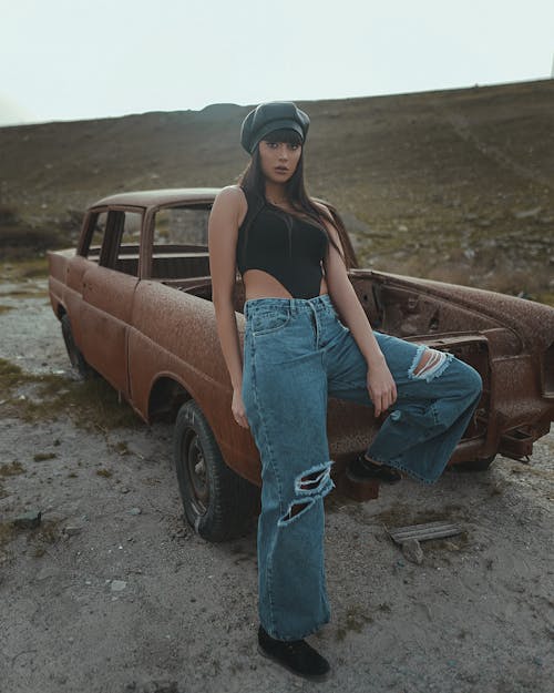 A Beautiful Model Posing on a Car Wreckage