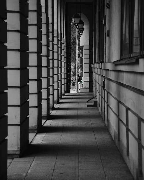 Grayscale Photo of an Outdoor Hallway