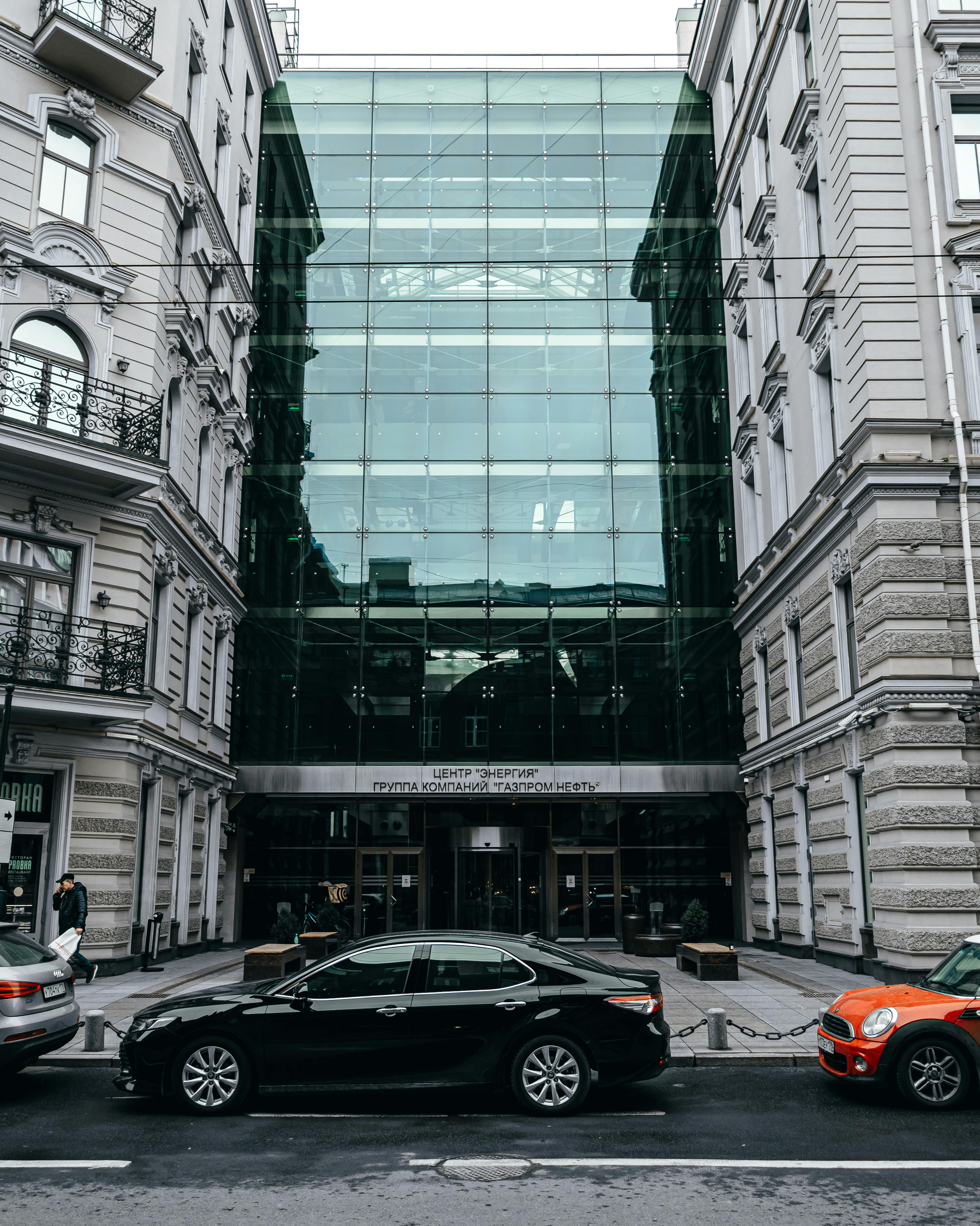 Photograph Of Cars Parked Between Buildings · Free Stock Photo