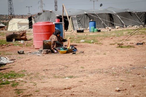A Refugee Washing Clothes