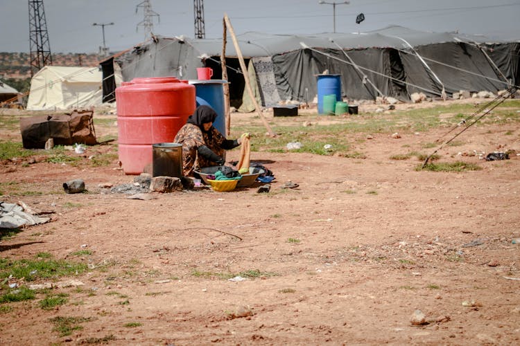 A Refugee Washing Clothes