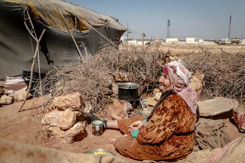 An Elderly Woman Cooking at a Refugee Camp