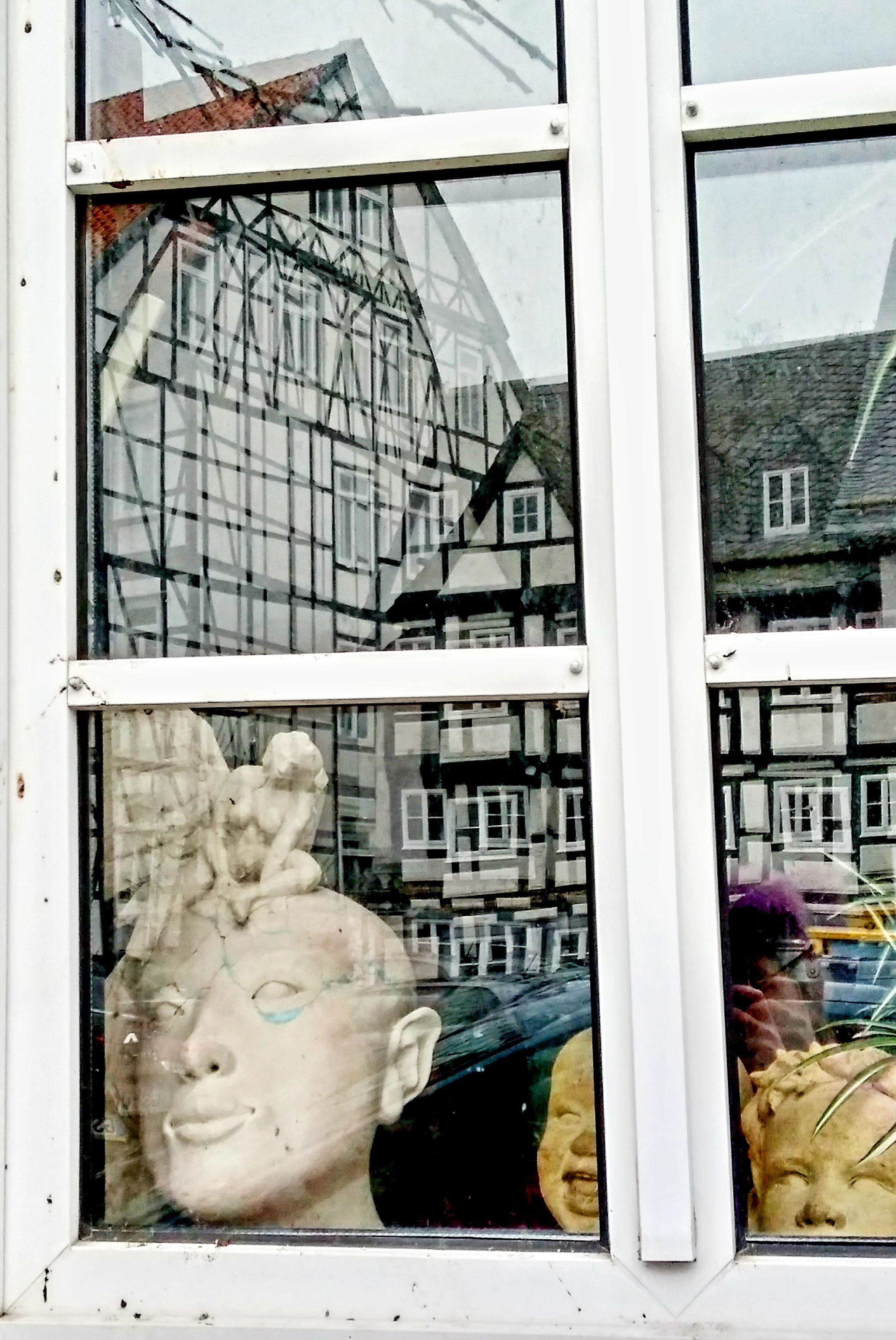 A White Framed Window with Sculptures · Free Stock Photo
