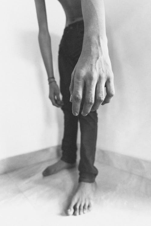 Grayscale Photo of a Person's Hand