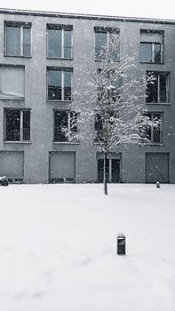 A peaceful scene of snowfall in front of a building in Konstanz, Germany, highlighting winter beauty.