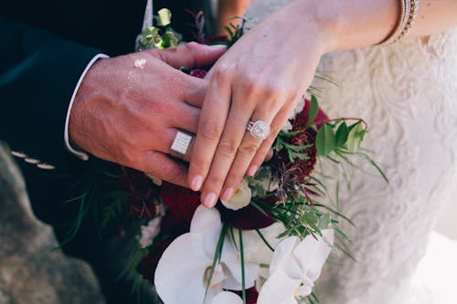 Person Wearing Silver Ring Holding White Flower Bouquet