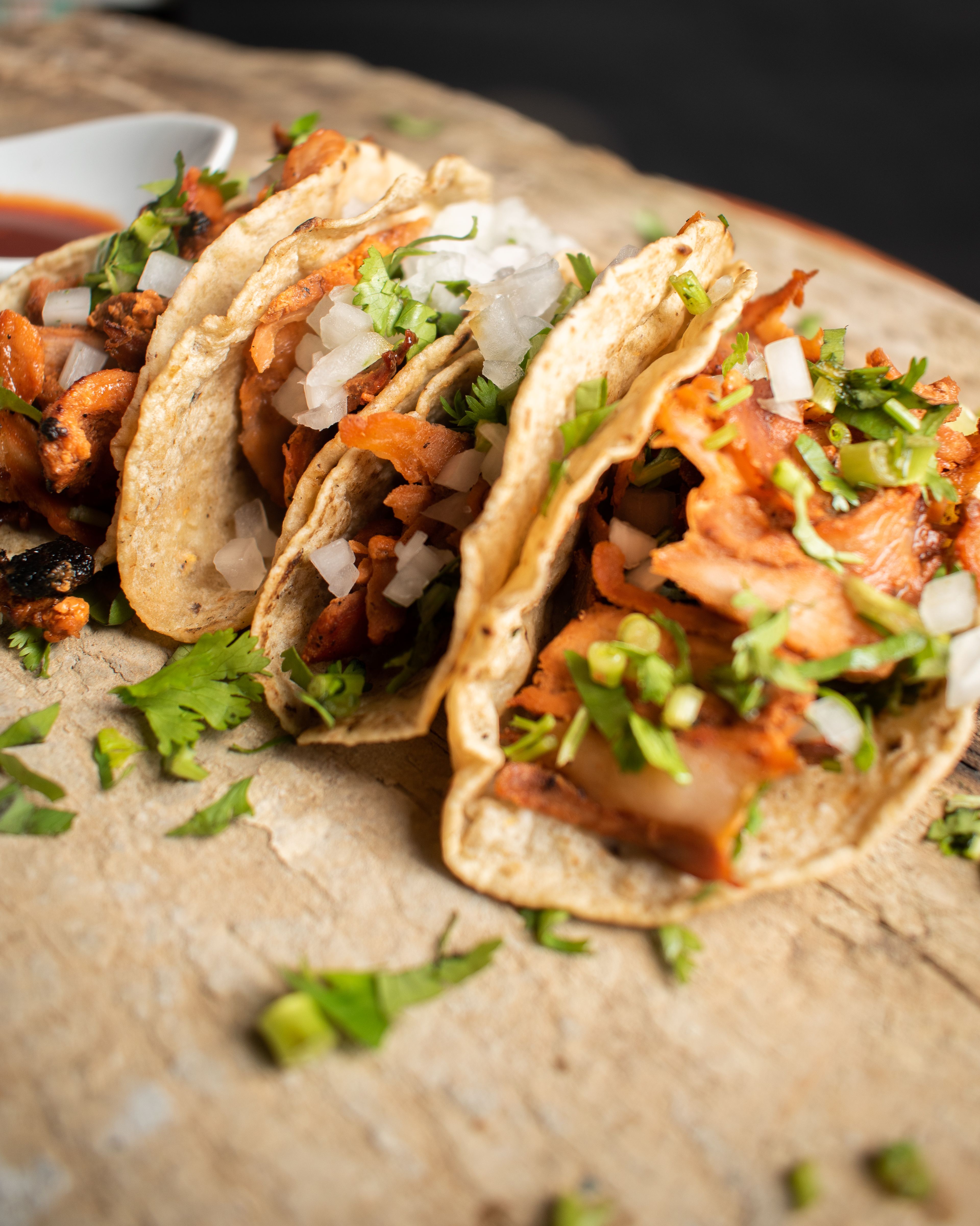Authentic Mexican tacos with onions and cilantro, perfect for a gourmet culinary experience.