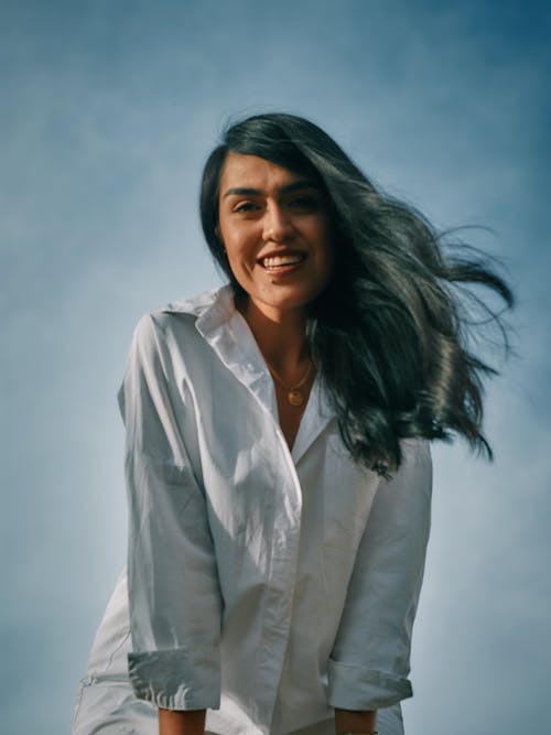 Free Photo of a Woman in a White Dress Shirt Looking at the Camera while Smiling Stock Photo