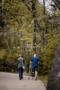 Man with fractured leg walking on path with woman