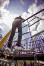 Active kid climbing on metal ladder