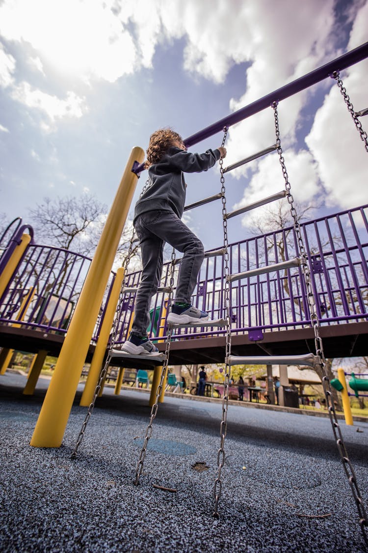 Kid Climbing On Ladder On Playground