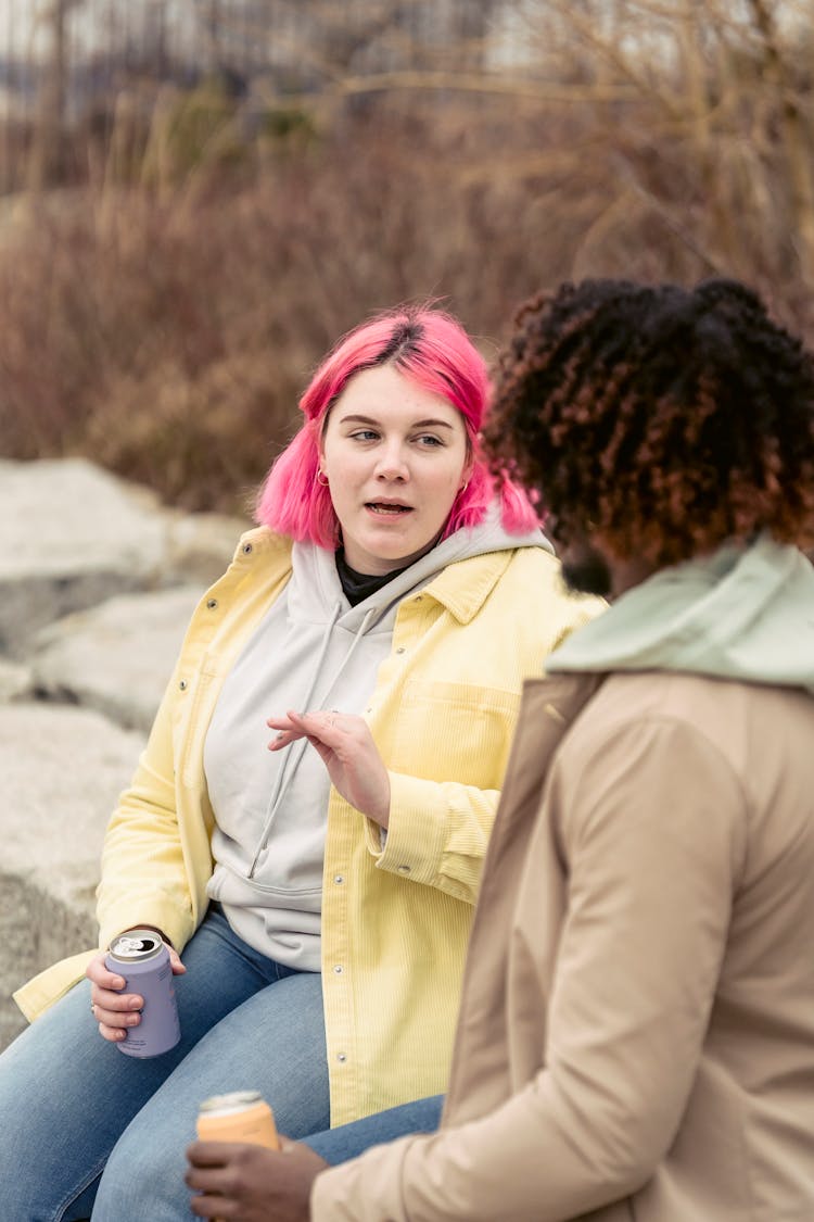 Diverse Couple Speaking On Boulders