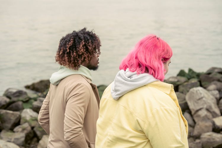 Anonymous Diverse Couple Walking On Embankment