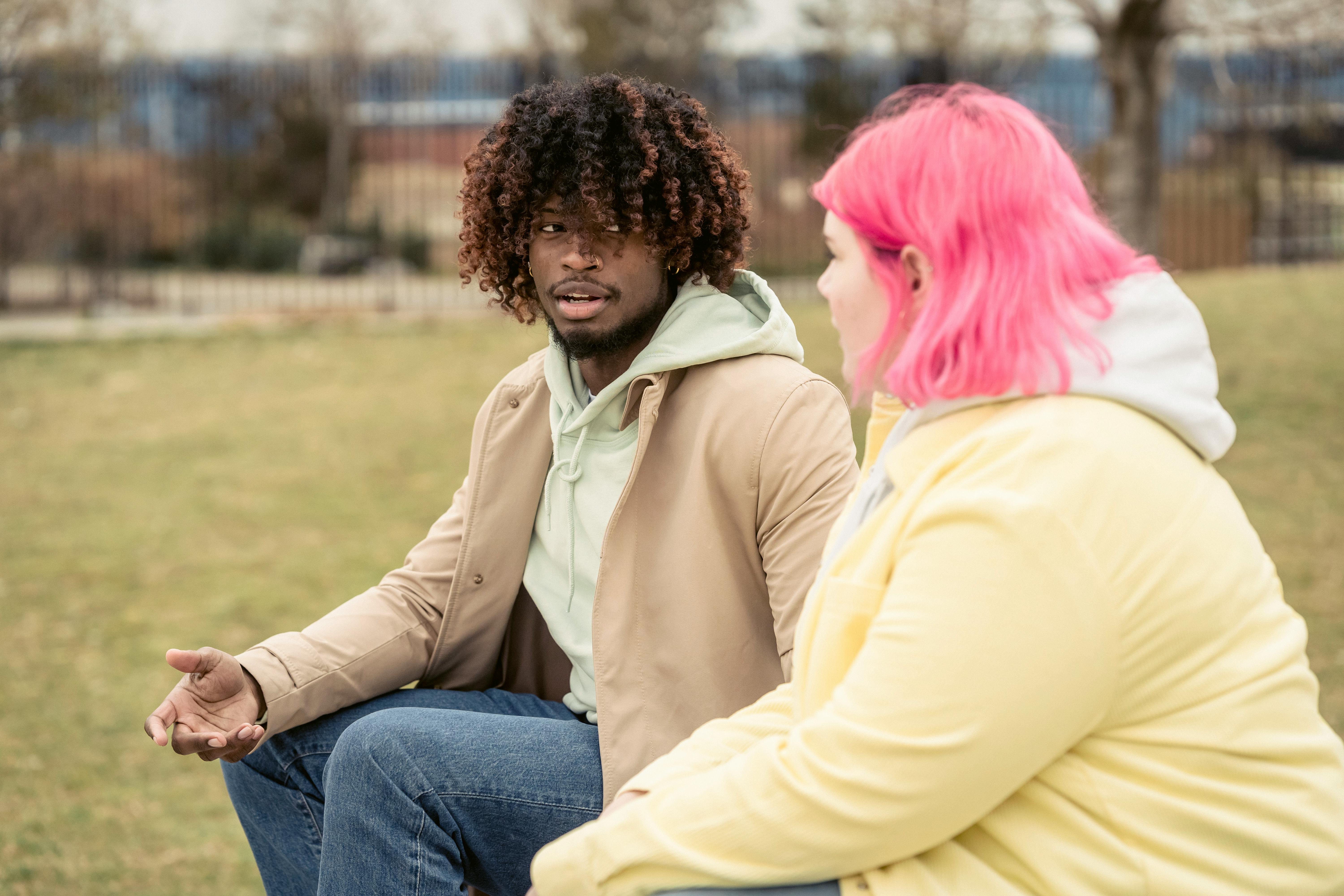 multiethnic couple sitting in park