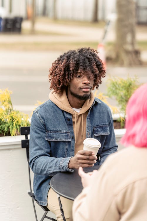 Free African American guy resting in cafeteria with girlfriend Stock Photo