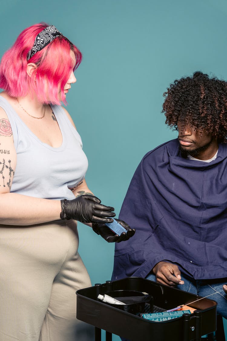 Female Stylist Showing Paint To Black Client