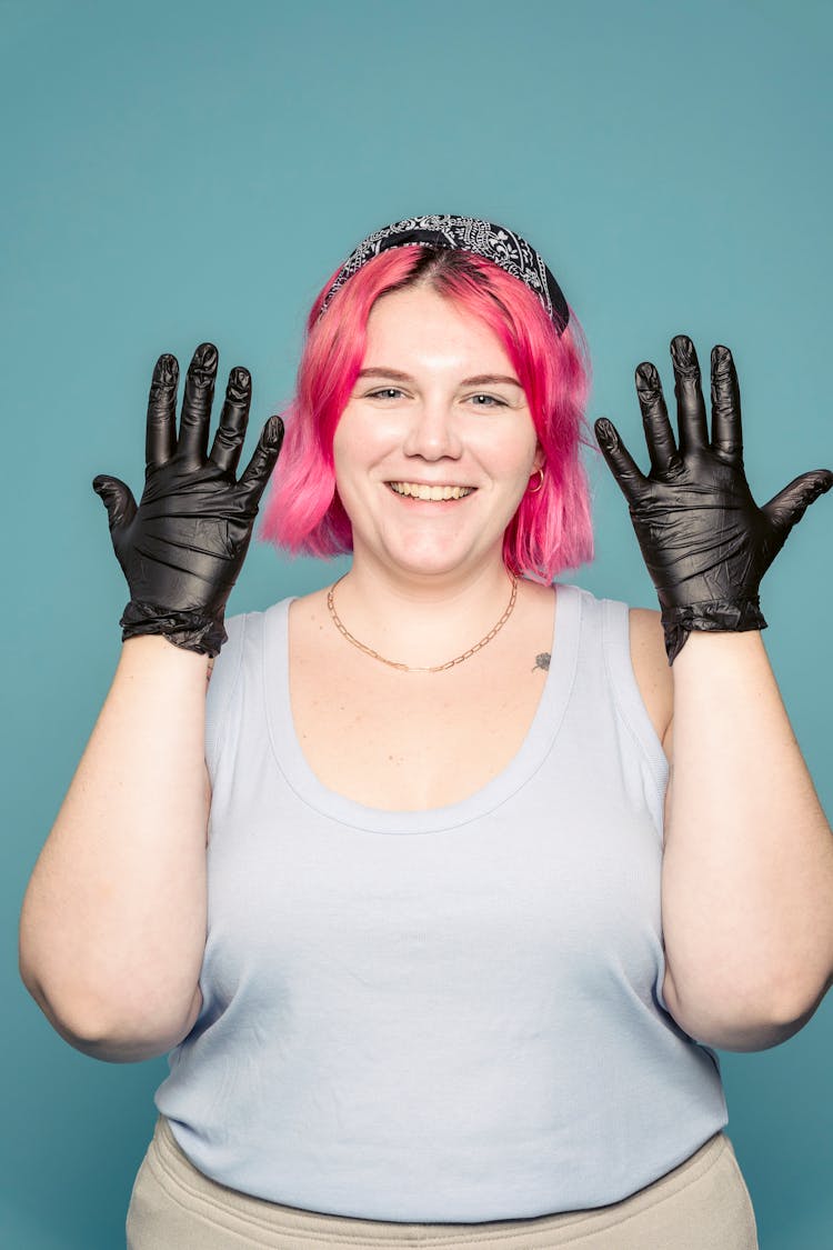 Happy Female Stylist Showing Gloves