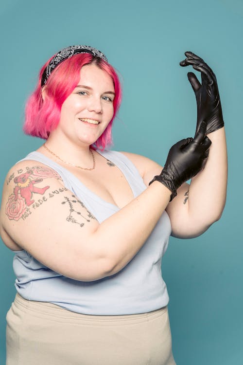 Cheerful woman putting on gloves