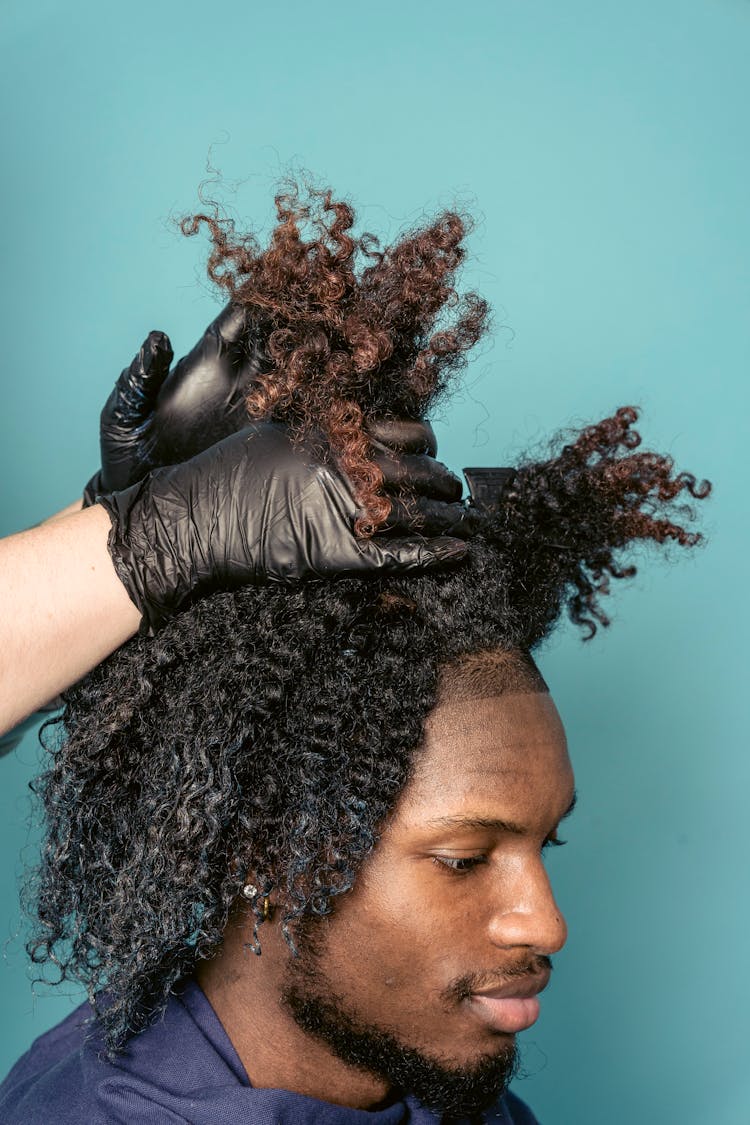 Stylist Doing Hairstyle For Black Man