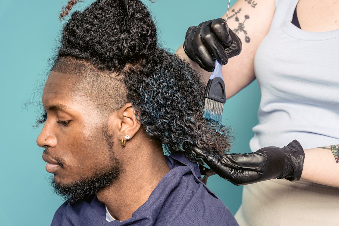 Tattooed woman dying hair to black man · Free Stock Photo
