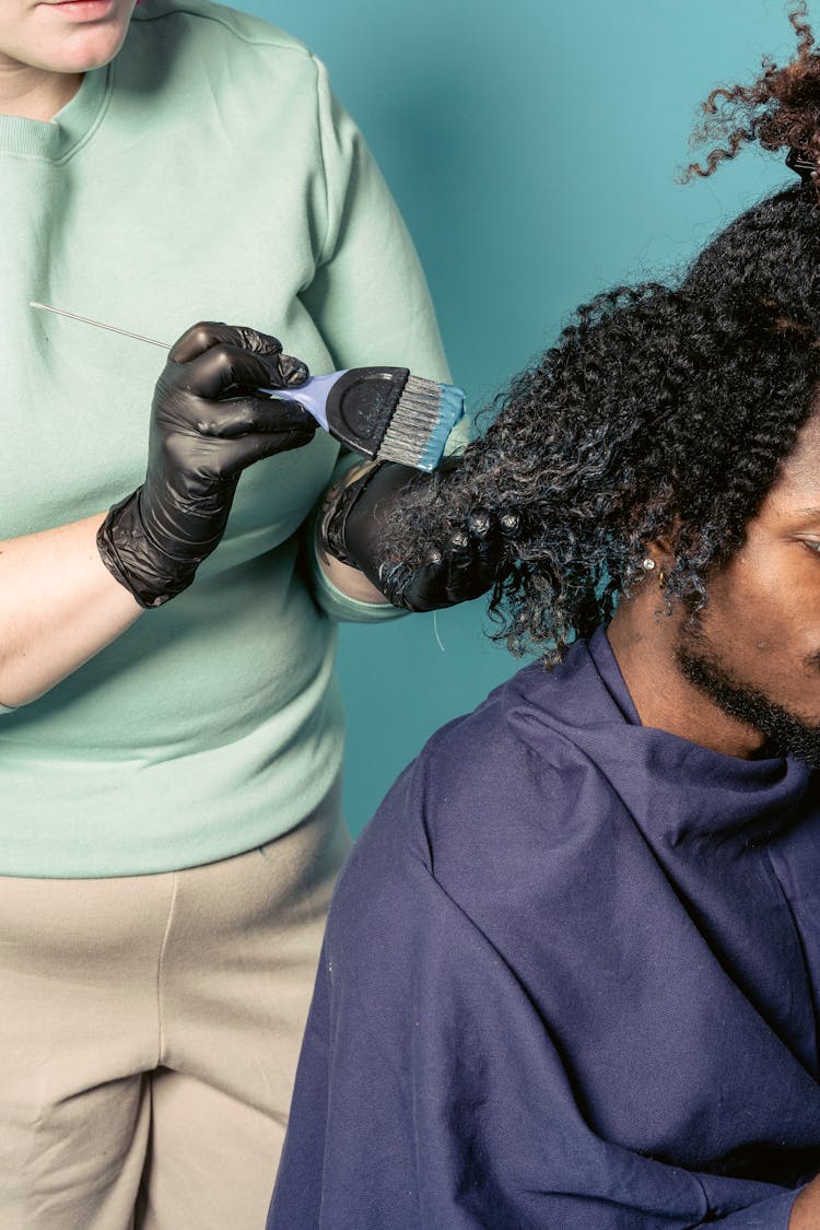 Woman Applying Hair Dye On Curls