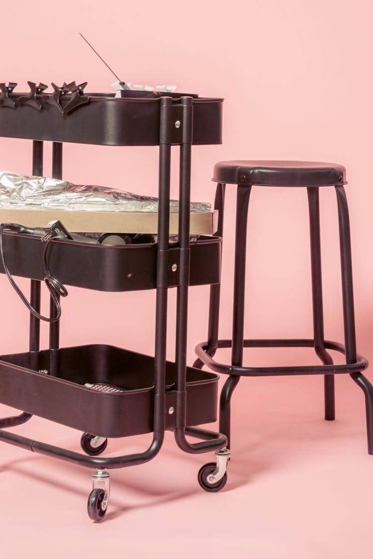 Chair Placed Near Cart With Hairdresser Instruments