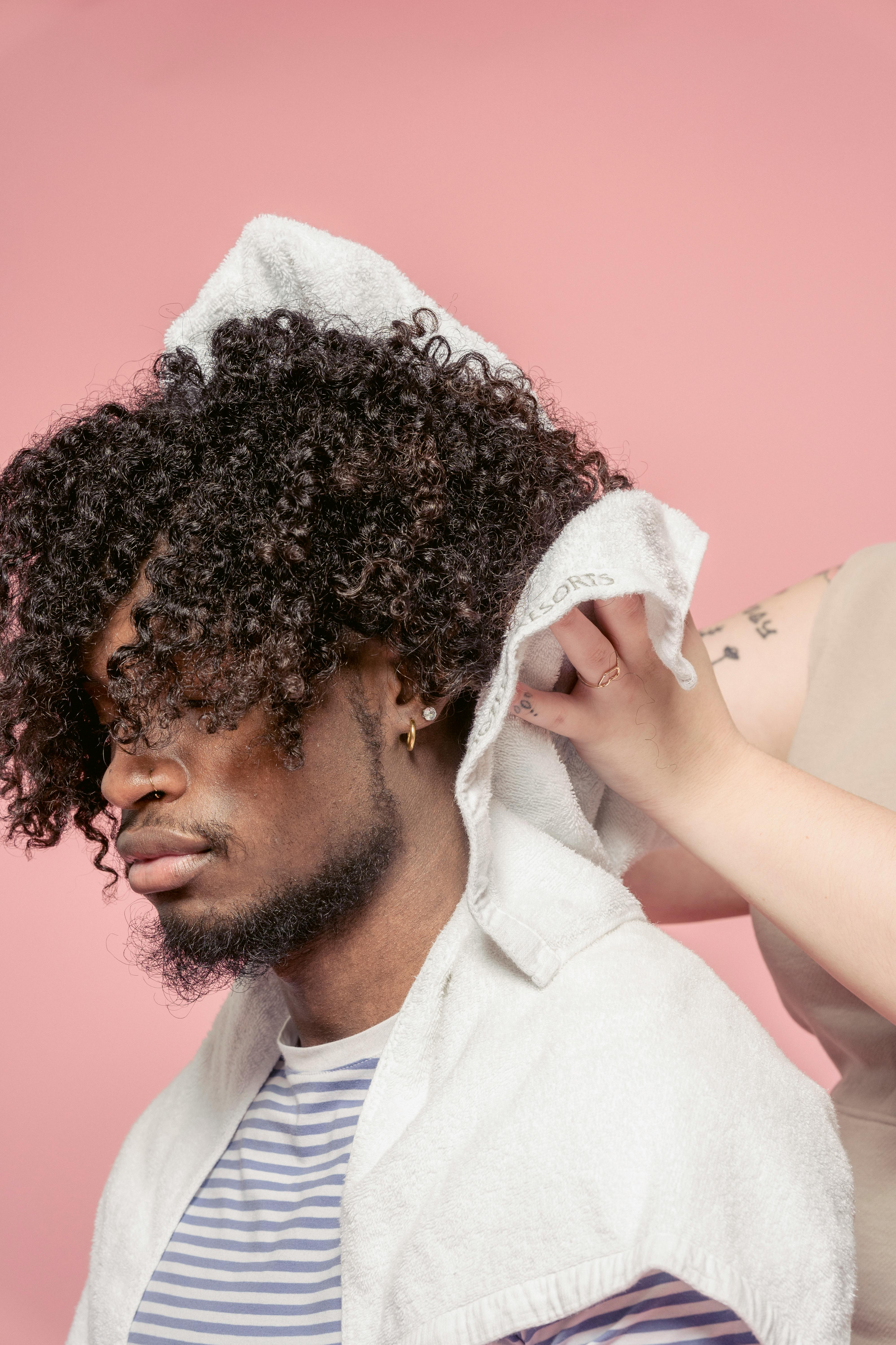 Cheerful woman drying hair of black man · Free Stock Photo Cheerful woman drying hair of black man · Free Stock Photo