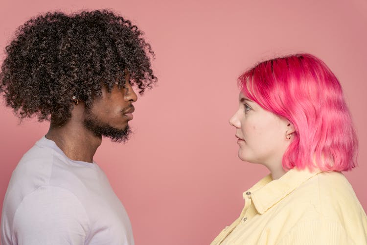 Diverse Couple Looking At Each Other In Studio