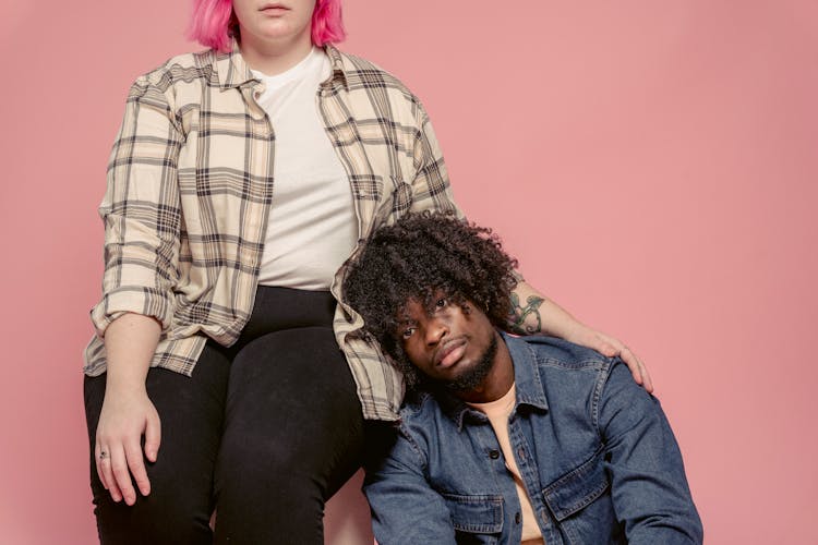 Plump Woman Embracing Black Man In Studio