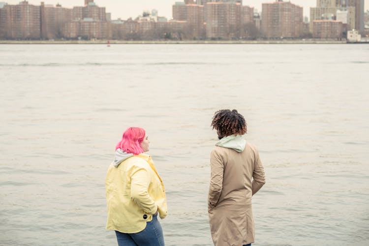 Diverse Friends Standing On Riverbank In City