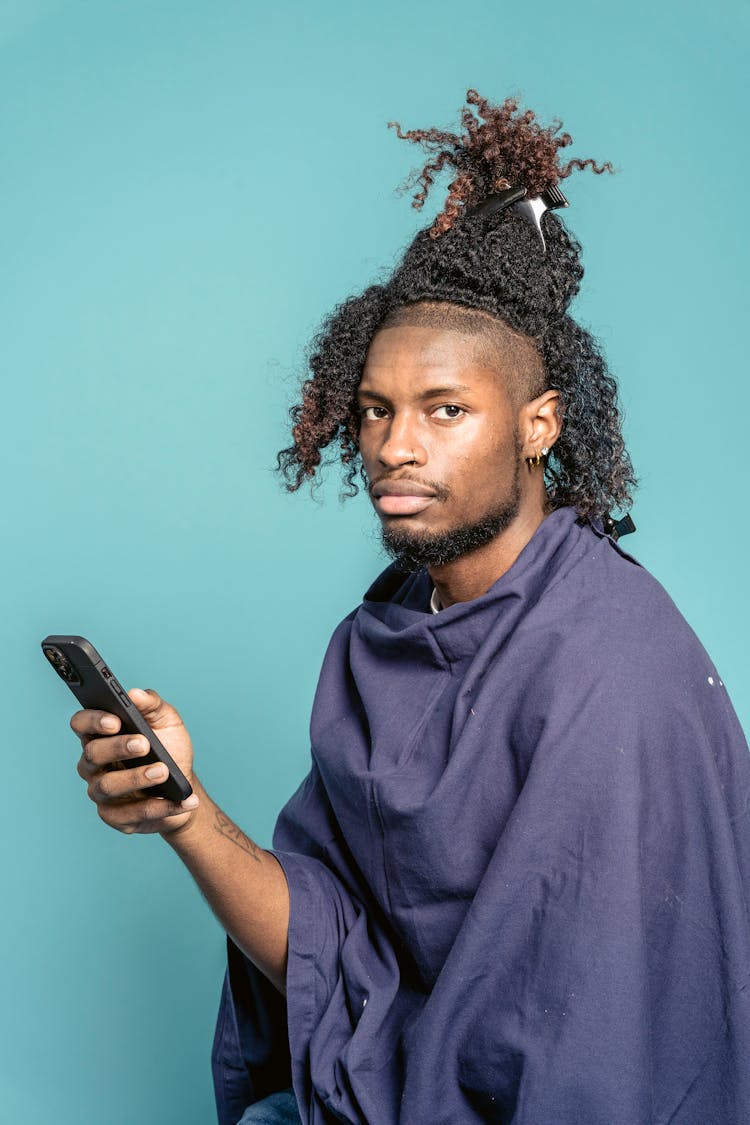 African American Man In Barber Cloak Using Smartphone