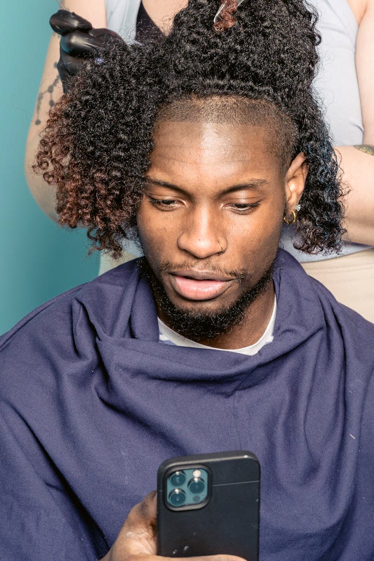 Black Man Taking Selfie With Smartphone During Haircut