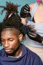 Black man and master dying hair in salon