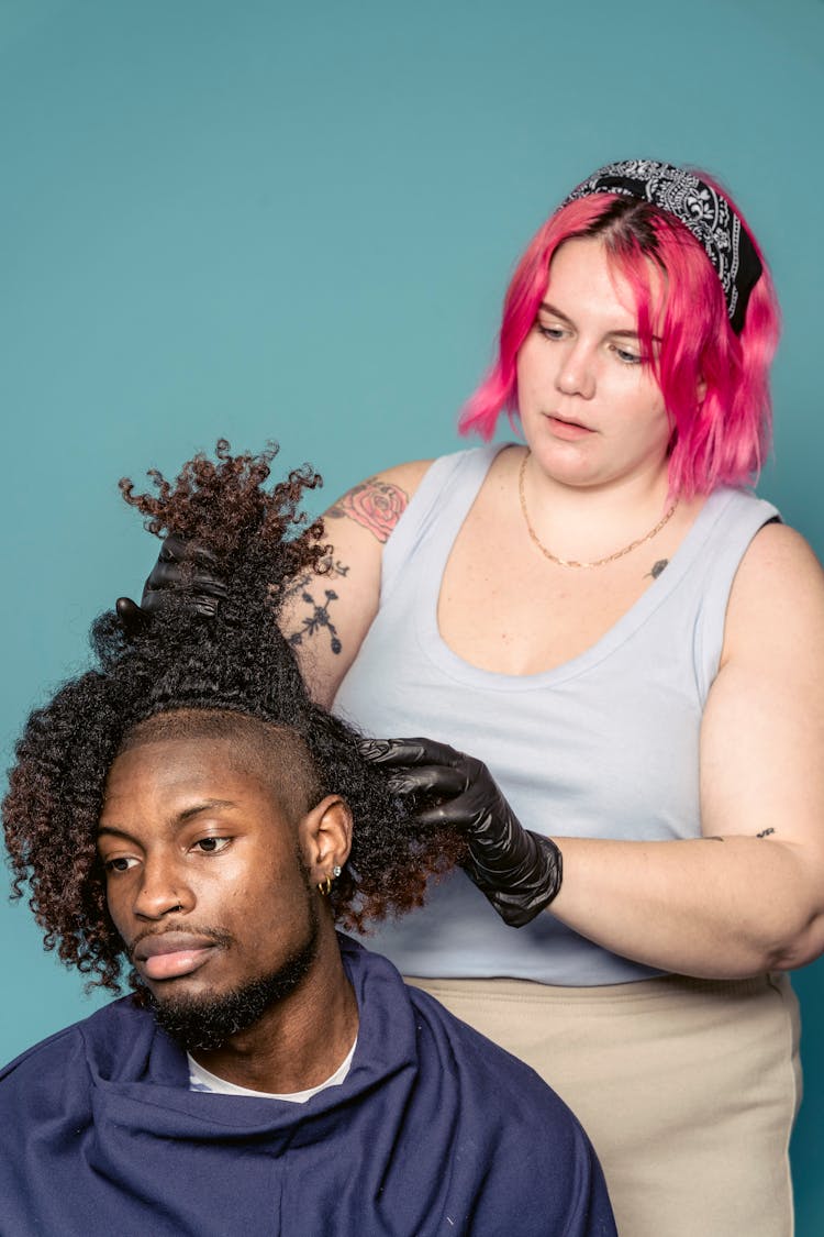 Young Woman Stylist Doing Hair Dye Procedure To Client