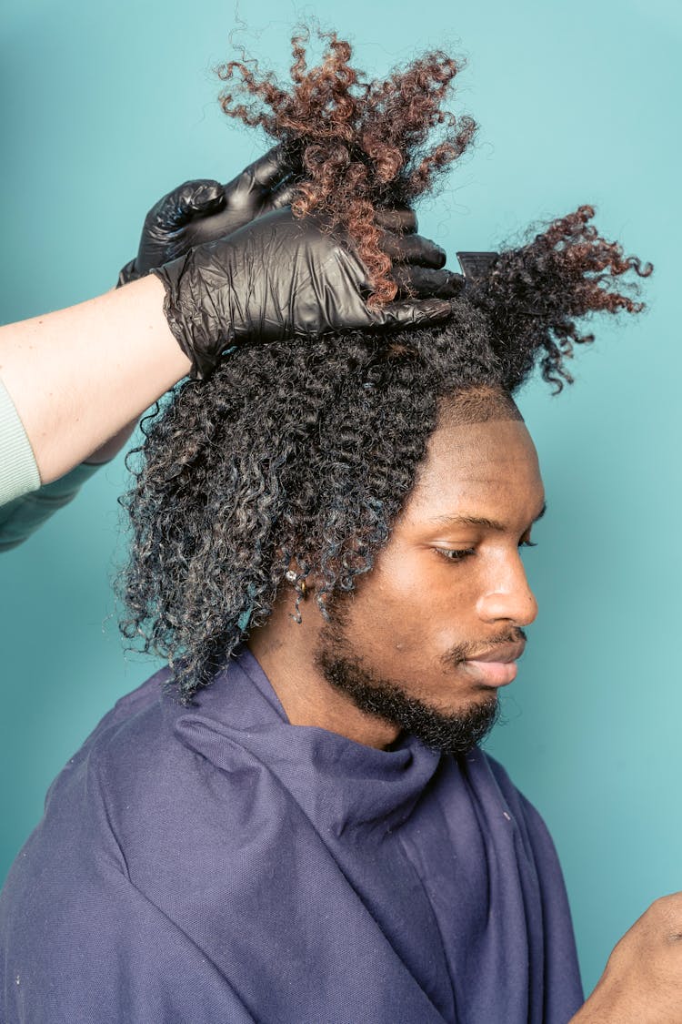 Stylish Black Man Sitting In Barbershop