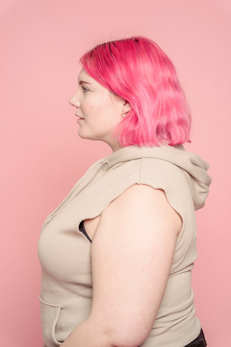 Serious Young Plus Size Woman In Pink Studio