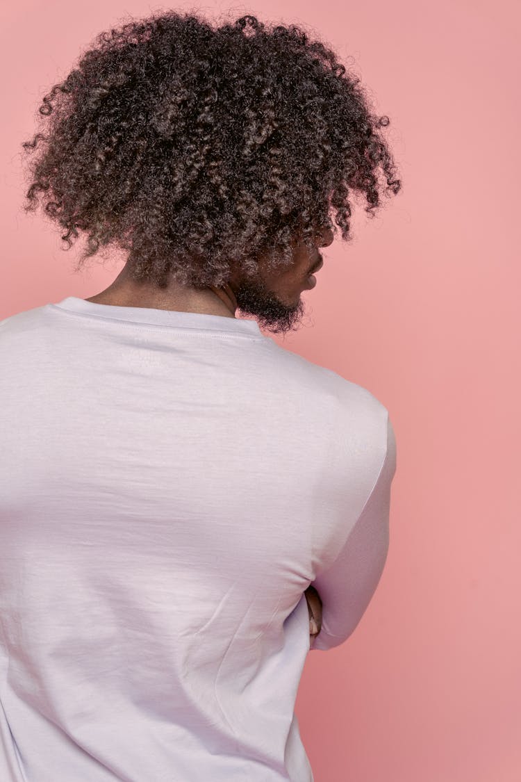 Black Man With Curly Hair In Pink Studio