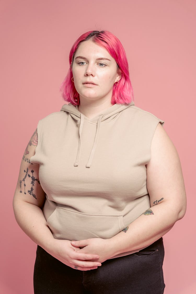 Serious Plump Woman With Bright Hair In Studio