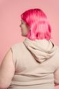 Serious young obese woman with colorful hair
