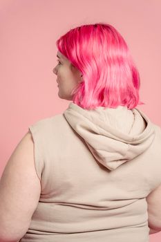 Serious young obese woman with colorful hair