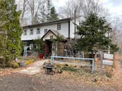 A White and Brown House Near Trees